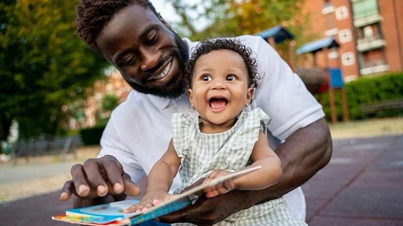 Happy child with father reading book Happy child with father reading book