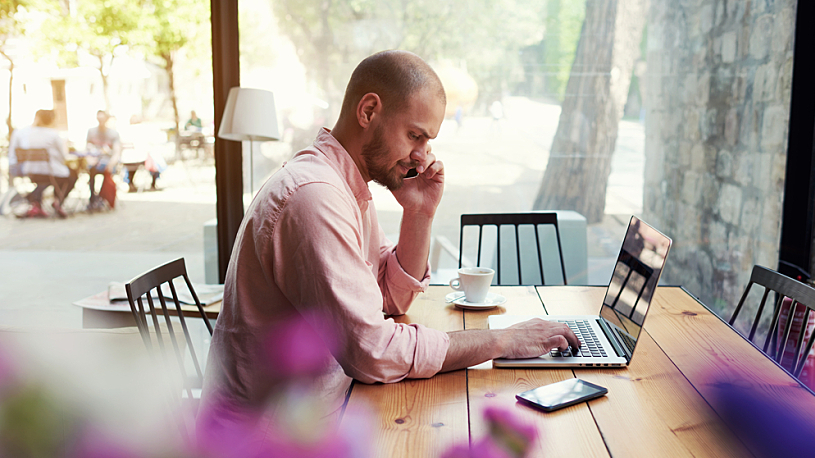 Male remote employee working at coffee shot Remote and Hybrid Employees: 4 Tips for Creating a Dynamic Working Relationship