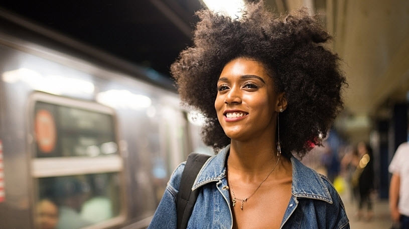 Happy woman going to work in New York City subway station New York to Require Written Agreements for Independent Contractors