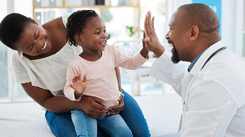 Image of mother with child giving doctor high five gesture Image of mother with child giving doctor high five gesture