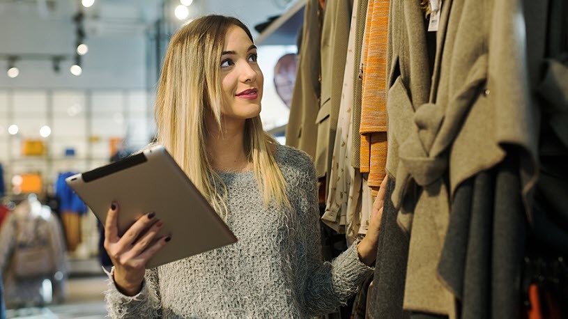 Smiling professional retail store manager inspects inventory Smiling professional female retail store manager inspects inventory