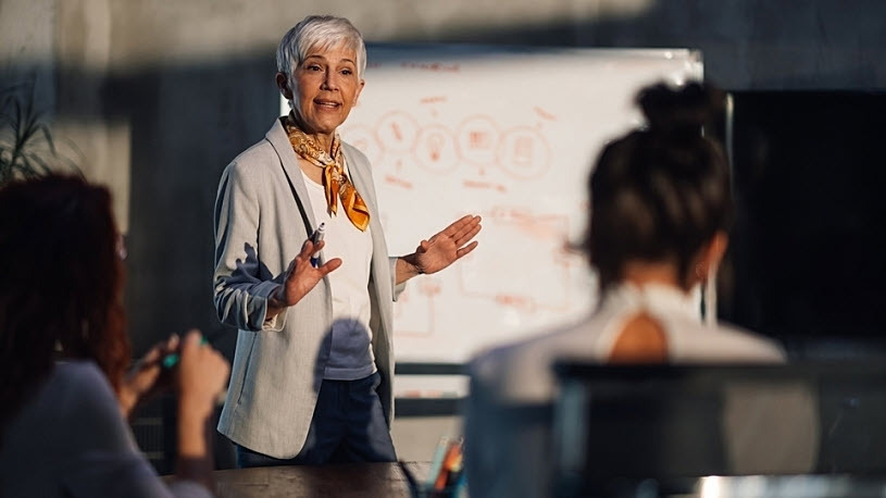 Mature female executive presents case for succession planning Mature female executive presents case for succession planning