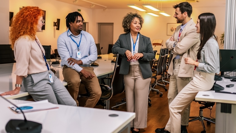 business team standing in office planning together business team standing in office planning together
