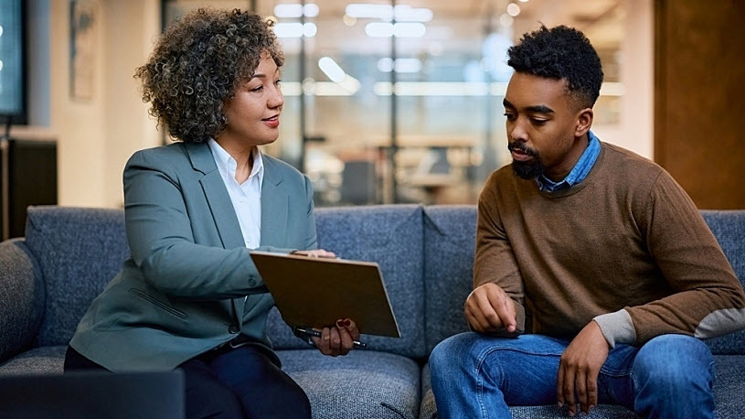 Female insurance broker meeting with male business owner Female insurance broker meeting with male business owner