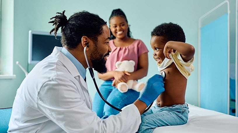 Black pediatrician examining happy both with mother there Black pediatrician examining happy both with mother there