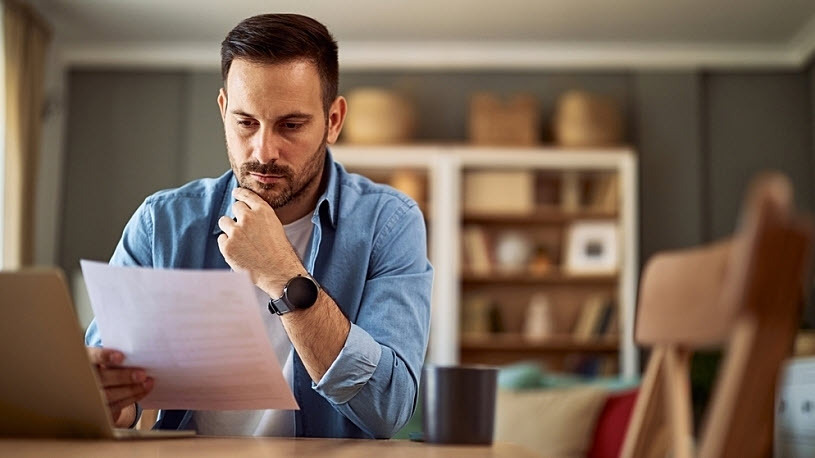 Business owner reads resignation letter from employee Business owner reads resignation letter from employee