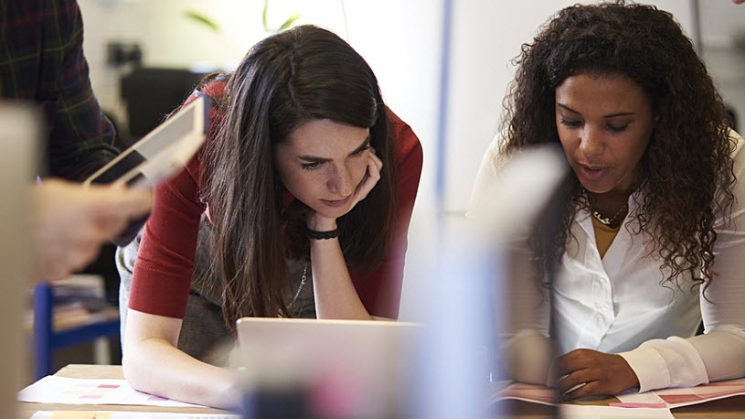 Young women coworkers collaborating at conference table Where You Work Counts: ACA State Reporting