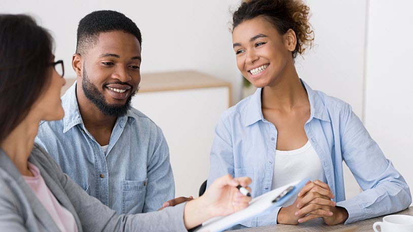 Cheerful Black couple meets with retirement benefits consultant Cheerful Black couple meets with retirement benefits consultant to review asset allocation