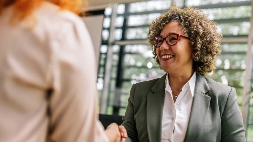 Two Women Shaking Hands After Meeting About Employee Expectations Manager and employee discussing employee expectations