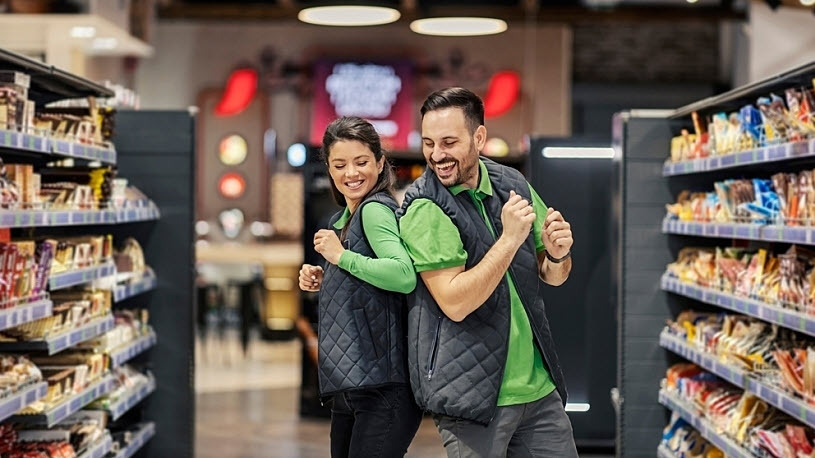 Playful supermarket employees having fun at marketplace Playful supermarket employees are dancing and having fun at marketplace