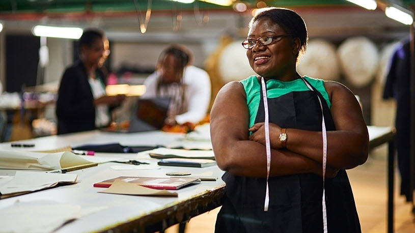 Smiling Black female business owner textile industry green shirt Smiling Black female business owner textile industry green shirt
