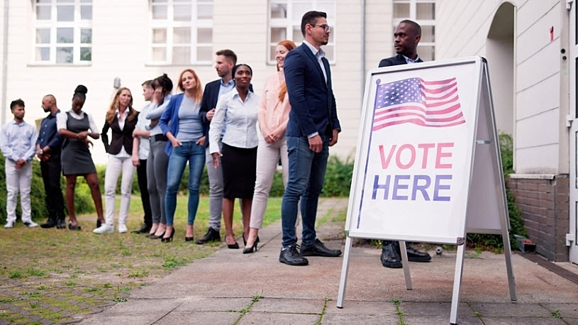 Diverse People At Voting Location. Vote Here Sign Diverse People At Voting Location. Vote Here Sign