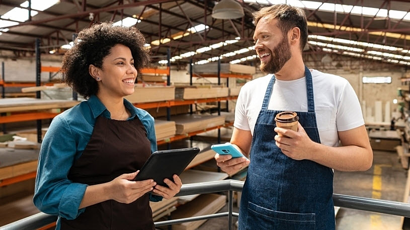 male and female coworkers laugh during part-time shift male and female coworkers laugh during part-time warehouse shift