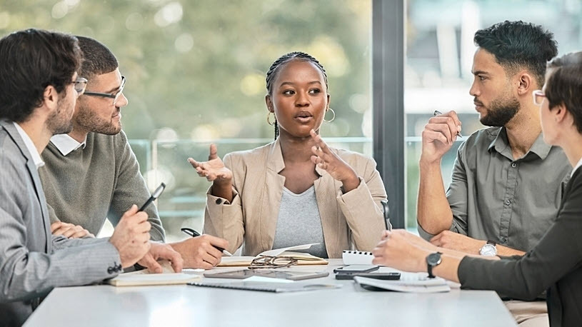 Business meeting around table among diverse colleagues Business meeting around table among diverse colleagues