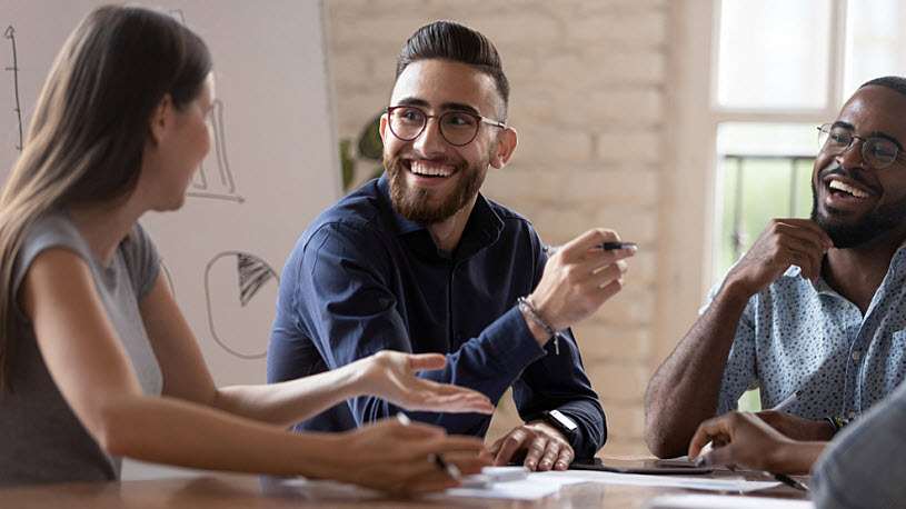 AI in HR Happy professionals collaborating with enthusiasm in a modern office setting.