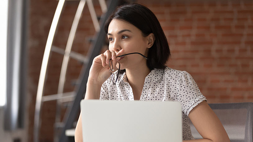 Thoughtful Asian businesswoman taking off glasses pondering ideas Thoughtful Asian businesswoman taking off glasses