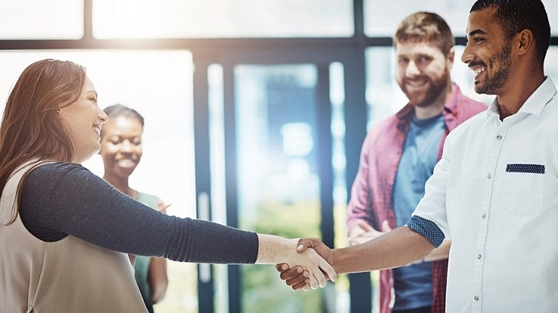 Diverse group of four businesspeople welcoming new employee Diverse group of four businesspeople welcoming new employee
