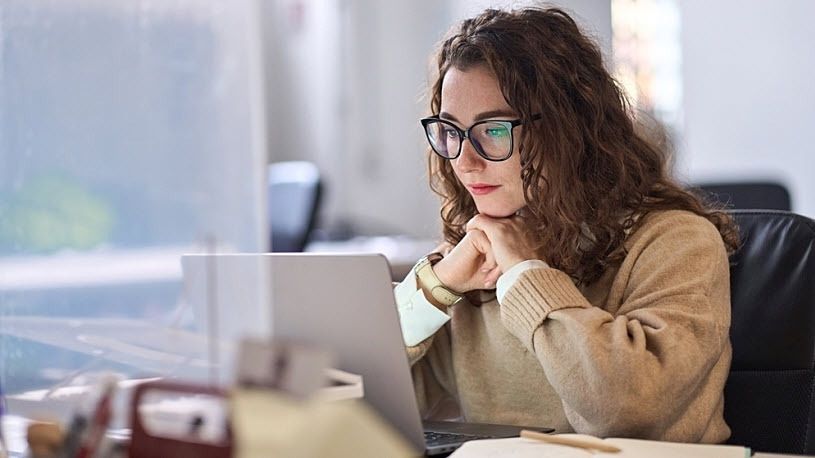 Young serious busy professional business woman using laptop Young serious busy professional business woman using laptop watching online training course