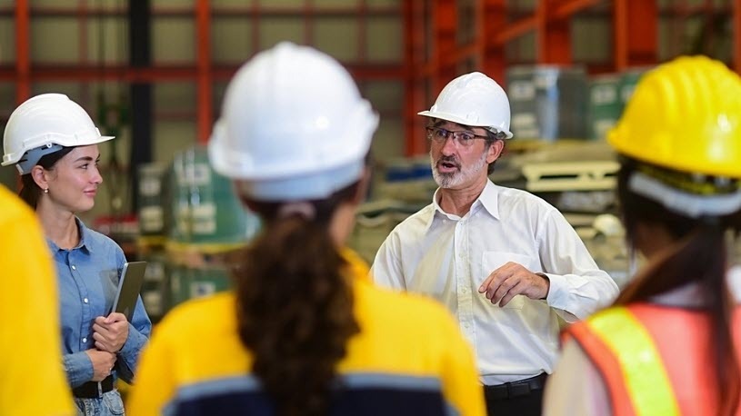 Manufacturing team having a meeting on the production floor Manufacturing team having a meeting on the production floor