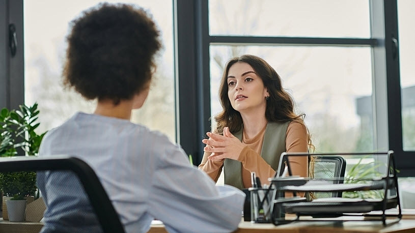 Two HR colleagues discuss employment law complaince Two HR colleagues discuss employment law compliance