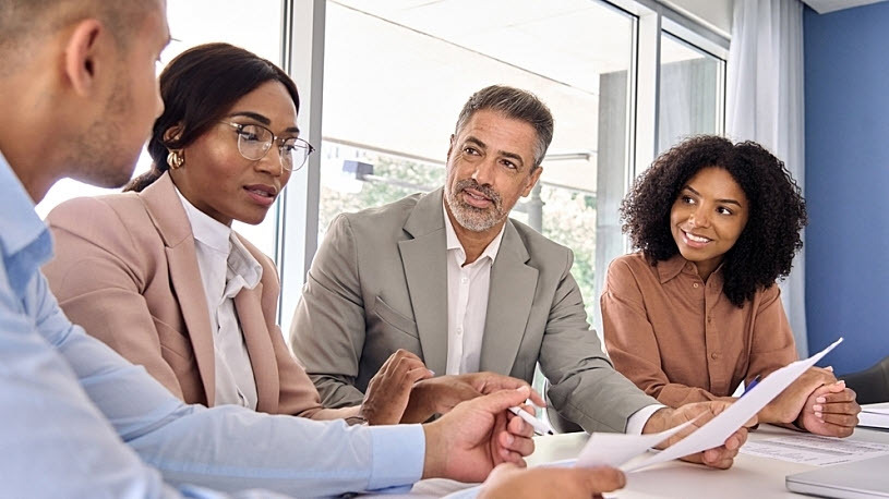 A diverse professional team meeting in a conference room Safe Harbor 401(k) Retirement Plans: Your Questions Answered