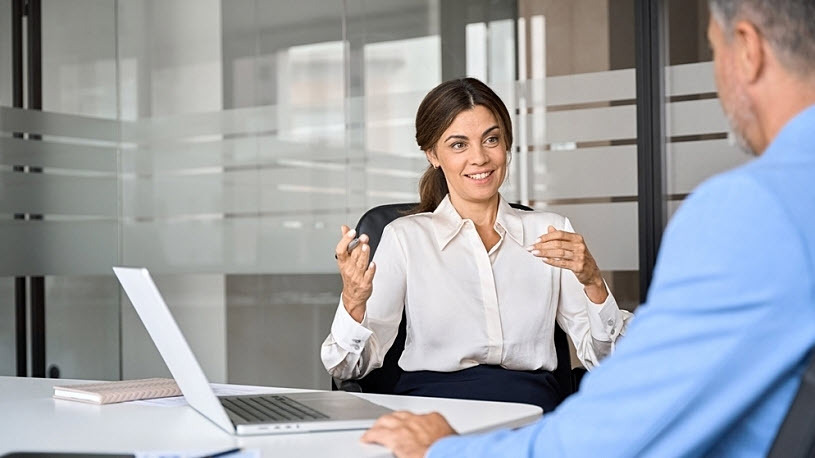 Business woman meets with insurance agent about health care plan Level-Funded Health Plans: 5 Key Insights Every Business Owner Should Know