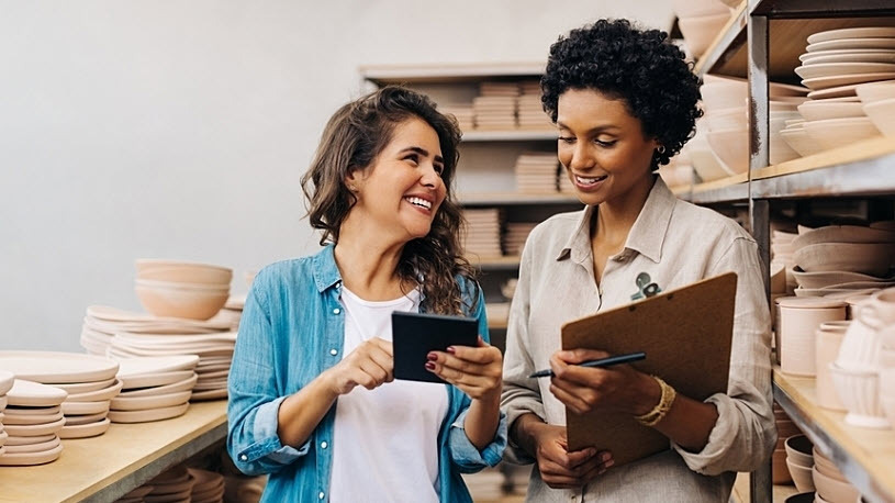 Female business owner and teammate smile Female business owner and teammate smile