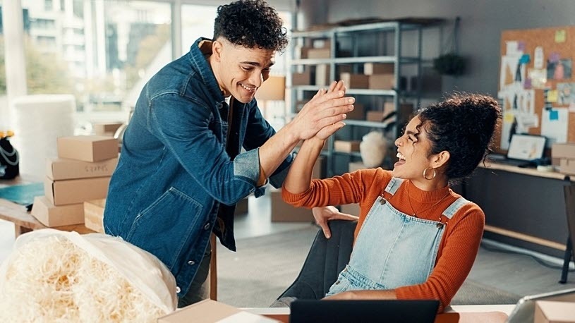 Two workers high fiving