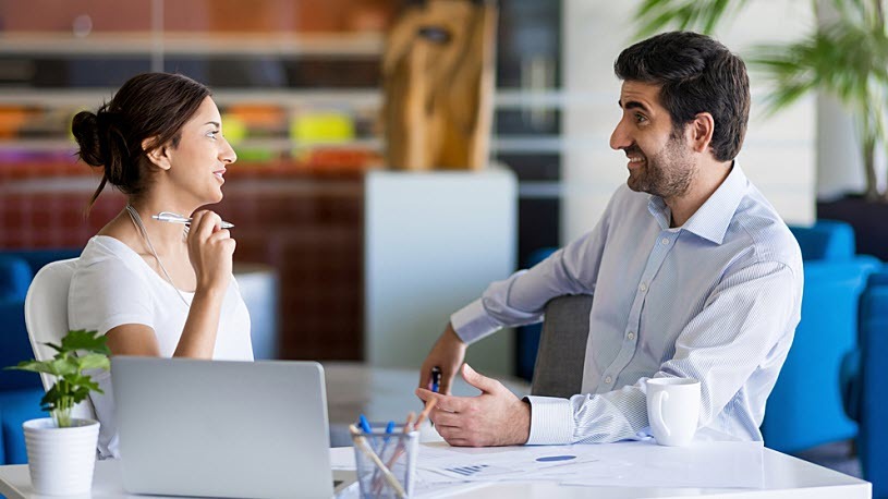 Two colleagues working together in an office