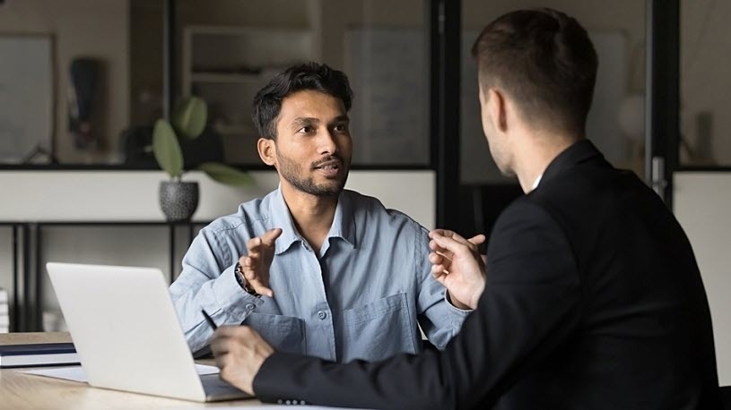accountant and client at a desk discussing tax plan
