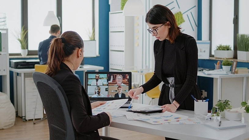 women talking to workmates on video call