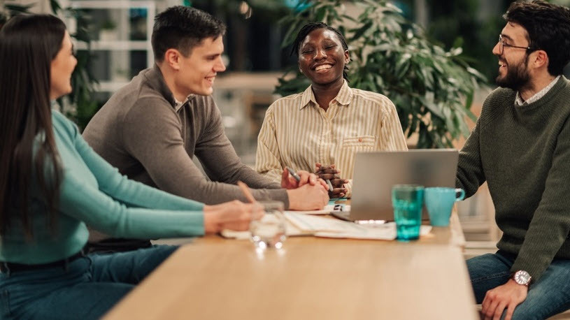 Small business owner and employees discussing a SIMPLE IRA