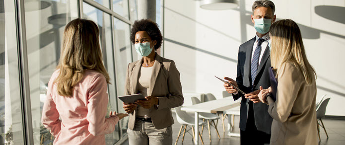 group of four people in office conference area group of four people in office conference area