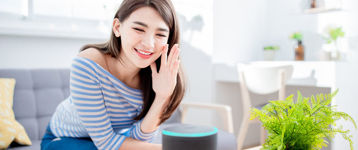 woman at home speaking to AI assistant