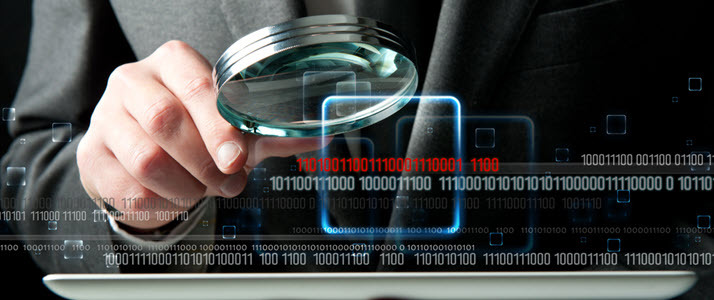 businessman uses looking glass to look at computer code businessman uses looking glass to look at computer code