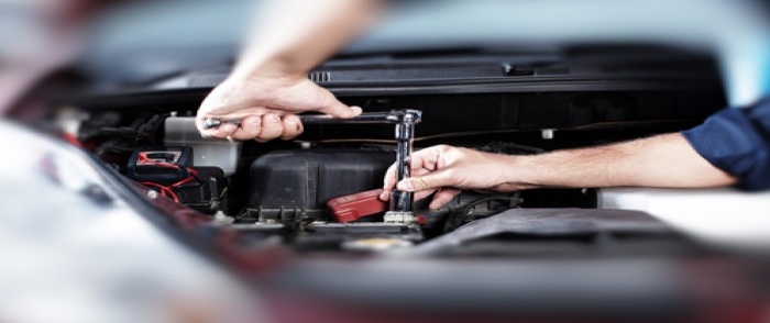 Airtech Automotive: Fueling Growth by Automating Payroll A mechanic works under the hood of a vehicle.