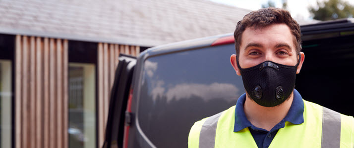 delivery man in mask and flourescent vest delivery man in mask and flourescent vest