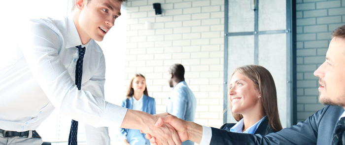 Businesspeople talking and shaking hands