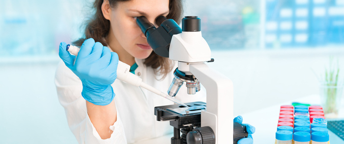 Are You Using the R&D Tax Incentive to Grow Your Business? A scientist does research using a microscope.