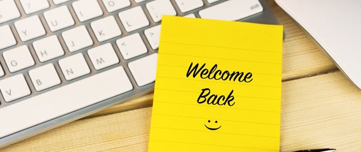 Back to Work in China A computer keyboard with a welcome back sticky note on it