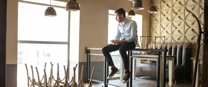 restaurant employee after hours looking on phone