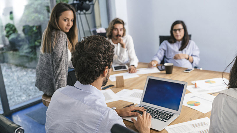 team using technology in conference room