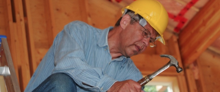 Baby Boomers Retiring A baby boomer construction worker wearing hard hat.