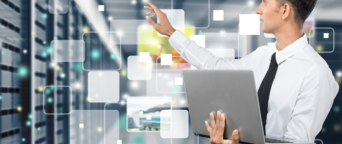 Data Platform as a Service: The Newest HCM Value Add? A man consults a laptop in a server room.