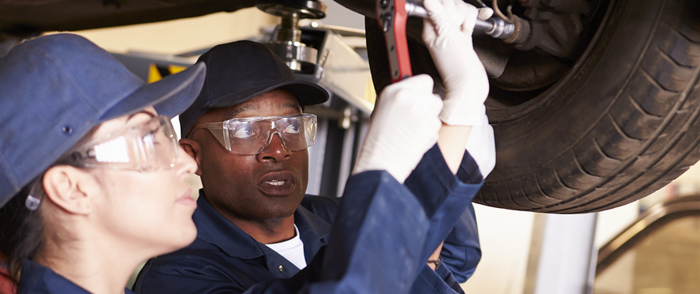 Protect Your Employees by Safeguarding Against the Fatal Four One auto mechanic instructing another
