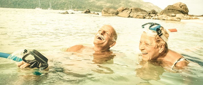 Senior couple having fun snorkeling