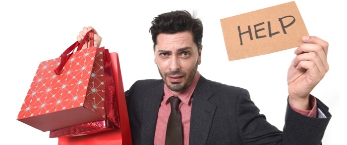 Seasonal Workforce Scheduling A man holds gift bags in one hand and a help sign in the other