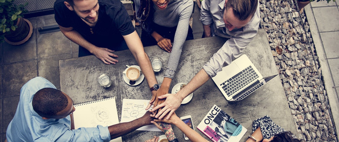 Are Income Inequality and Economic Growth Related? Colleagues collaborate in the workplace.