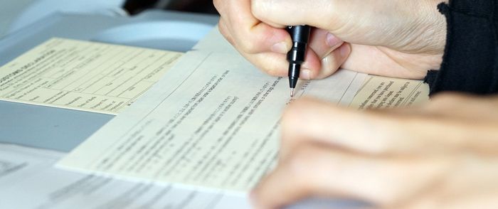 An employee signs a written form.