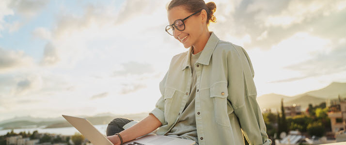 Myth-Busting 3 New Realities of the World of Remote Work A young woman working on laptop outside